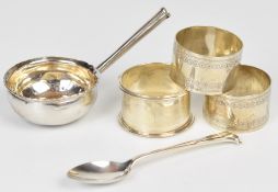 Three hallmarked silver napkin rings, weight 73g, coin based ladle and a silver plated teaspoon