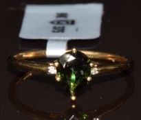 A 9k gold ring set with a pear cut chrome tourmaline of approximately 0.57ct and two diamonds,