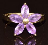 A 9k white gold ring set with five marquise cut Ceylon purple sapphires, the total carat weight