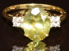 An 18k gold ring set with an oval cut Capelinha sphene of approximately 2.5ct and diamonds, with