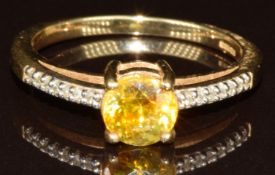 A 9k gold ring set with a round cut sphalerite of approximately 0.9ct and diamonds, with