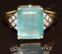 A 14k gold ring set with an emerald cut grandidierite of approximately 4.3ct and diamonds, 4.9g,