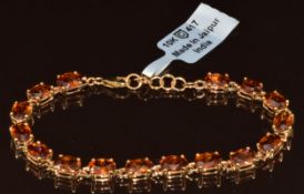 Tomas Rae 9ct gold bracelet set with sixteen oval cut cognac zircons, with Gemporia certificate, 9.
