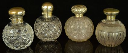 Four hallmarked silver mounted cut glass scent/perfume bottles, tallest 12cm