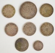 Eight Meiji-era Japan silver coins 1870-1871 consisting of a Year 4 (1871) 50 Sen with a 19mm circle