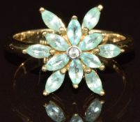 A 9k gold ring set with twelve marquise cut Paraiba tourmaline and a white sapphire in a cluster,