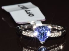 A 9ct white gold ring set with a trillion cut tanzanite of approximately 0.87ct and eight white