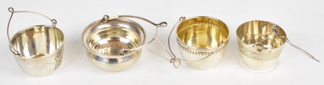 Four French and similar continental silver tea strainers, one marked souvenir de Rouen, width of