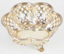 George V hallmarked silver bon bon dish with lobed and pierced body, raised on three feet,