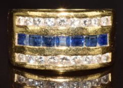 An 18ct gold ring set with calibre cut sapphires and two rows of round cut diamonds, 16.4g, size M
