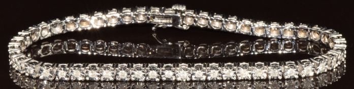 A 9ct gold bracelet set with fifty-one diamonds in illusion settings, 11.7g, 19cm
