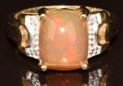 A 9k gold ring set with a Kalimaya opal cabochon of approximately 2.6ct and four diamonds, 4.7g,