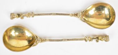 Pair of Victorian hallmarked silver gilt serving spoons with finely cast handles terminating in
