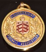 A 9ct gold Gloucestershire Football Association medallion set with enamel and engraved 'Northern