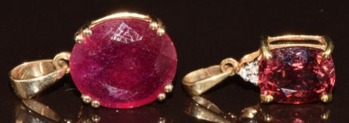 Two 9k gold pendants, one set with a Malaya garnet and diamonds and the other a garnet, one with
