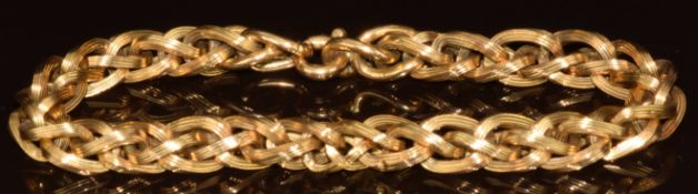 An 18ct gold plaited bracelet made up of textured links, 15.4g, 21cm