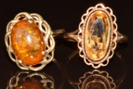 Two 9ct gold rings, one set with pressed amber and the other with citrine, 6.4g, size L/M & P