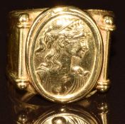 An 18ct gold ring depicting a young woman, 6g, size N