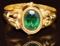 A yellow metal ring set with green paste, 2.9g, size Q