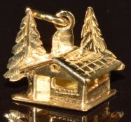 An 18ct gold charm in the form of an Alpine chalet, 1.3g
