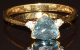 An 18k gold ring set with a trilliant cut Russian Alexandrite of approximately 0.7ct and two