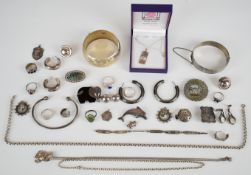 A collection of silver jewellery including locket, two bangles, seven rings, six pairs of