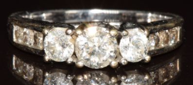 An 18k white gold ring set with three round brilliant cut diamonds, total diamond weight