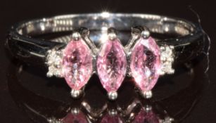 An 18k white gold ring set with three marquise cut Padparadscha sapphires and diamonds, size N/O