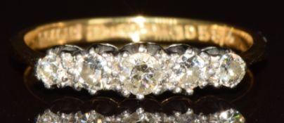 An 18ct gold ring set with five diamonds in a platinum setting, 2.3g, size M