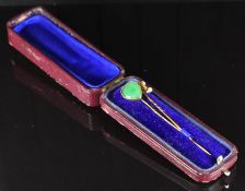An 18ct gold stick pin set with a heart cut jadeite cabochon and a yellow metal c1900 stick pin