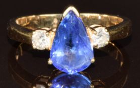 A 14k gold ring set with a pear cut tanzanite of approximately 1.25ct and two round cut diamonds,