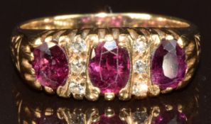 A 9ct gold ring set with three oval cut rubies, each approximately 0.4ct, and six diamonds, 3.4g,