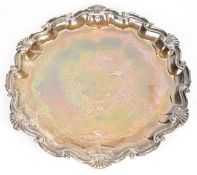 Victorian hallmarked silver salver with shaped edge and engraved decoration, raised on three ball