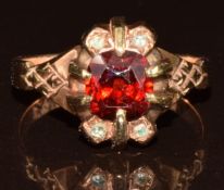 A yellow metal ring set with a cushion cut garnet and rose cut diamonds, 3g, size L (tests as 9k
