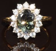 A 14k gold ring set with an oval cut AAA green tanzanite of approximately 2.45ct surrounded by