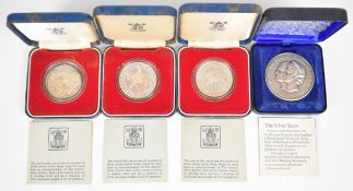 Three cased silver crowns and a silver anniversary medal, 62g, all with certificates