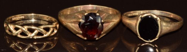 Three 9ct gold rings, one set with onyx and one an oval cut garnet, 7.5g, size Y, X & M