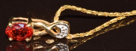 A 9k gold pendant set with an oval cut sunset ruby of approximately 0.6ct and a diamond, with