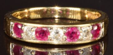 An 18ct gold ring set with round cut rubies and diamonds, 3.5g, size N