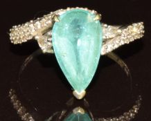 An 18k white gold ring set with a pear cut Paraiba tourmaline of approximately 3ct and diamonds,
