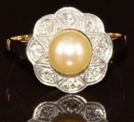 c1900 gold ring set with a pearl of approximately 6.7mm surrounded by diamonds in a platinum