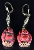 A pair of Neiger earrings made up of red beads in the form of Buddha