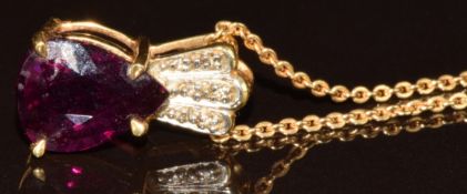 An 18k gold pendant set with a pear cut magenta garnet of approximately 4.9ct and diamonds, on 18k