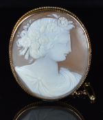 A 9ct gold brooch set with a cameo depicting a woman, 14.5g, 4 x 5cm