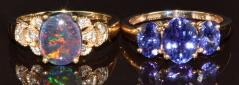 Two 9k gold rings, one set with an opal triplet and diamonds and the other with three oval cut