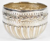 Victorian hallmarked silver sugar bowl with wrythen lower body and embossed scroll decoration,