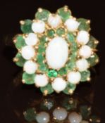 A 9ct gold ring set with round cut emeralds and opal cabochons in a cluster, 4g, size O/P