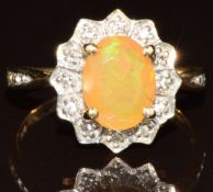 A 9k gold ring set with an Indonesian opal cabochon surrounded by white zircon, with certificate,