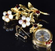 A 9ct gold brooch set with garnets and pearls with a drop rotary watch, 10.8g, 3.6 x 4.2cm