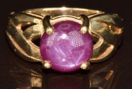 A 9k gold ring set with a round Kamataka star ruby cabochon of approximately 4.8ct, with